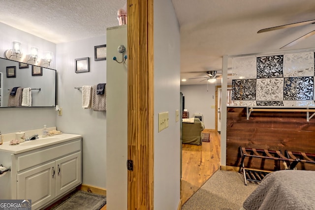 bathroom featuring vanity, a textured ceiling, and ceiling fan