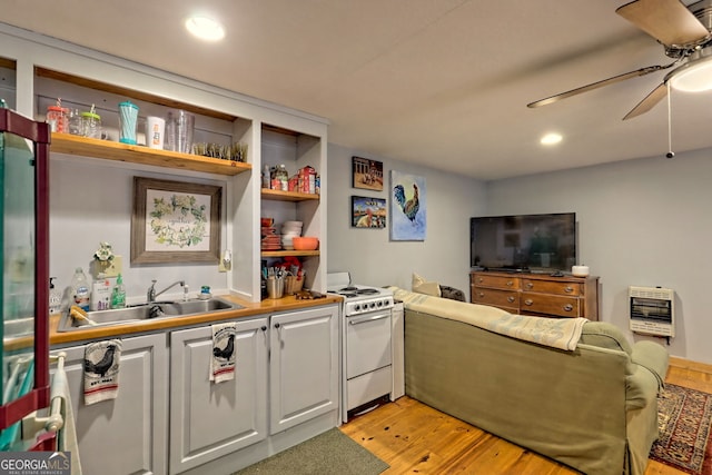 interior space featuring sink, ceiling fan, and light hardwood / wood-style floors