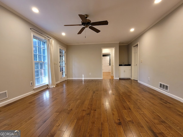 unfurnished living room featuring ceiling fan, hardwood / wood-style floors, and crown molding