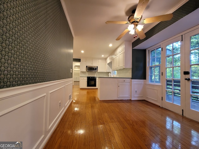 kitchen with ceiling fan, white cabinets, french doors, crown molding, and light hardwood / wood-style floors