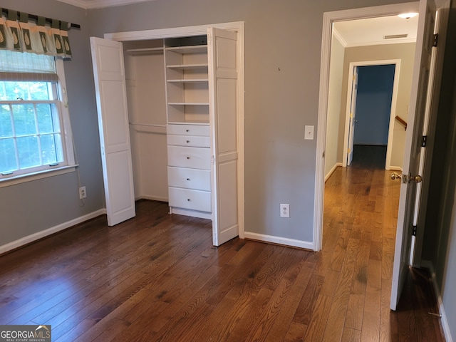 unfurnished bedroom with dark hardwood / wood-style floors and crown molding