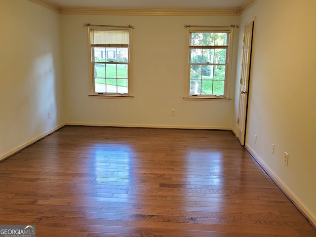 unfurnished room with ornamental molding, hardwood / wood-style flooring, and a healthy amount of sunlight