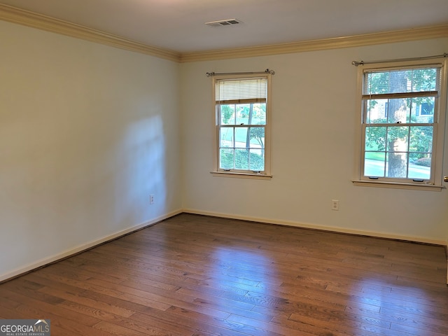 unfurnished room featuring hardwood / wood-style floors and ornamental molding