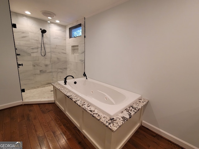 bathroom featuring hardwood / wood-style floors and independent shower and bath