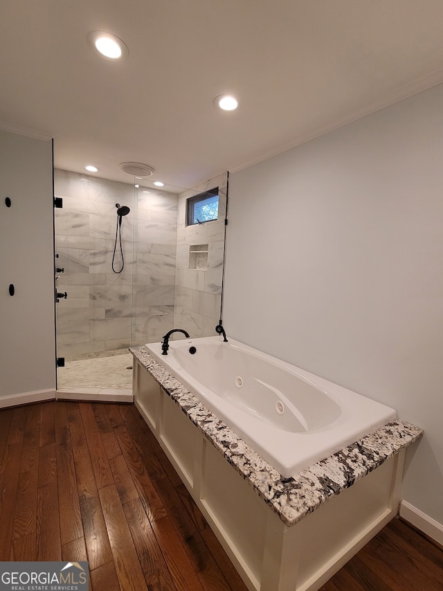 bathroom featuring wood-type flooring and a washtub