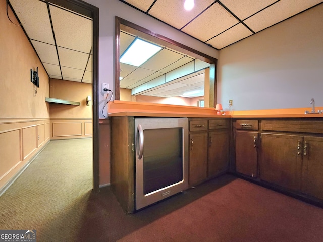 bar featuring dark carpet, a paneled ceiling, and sink