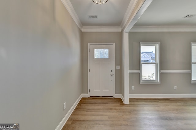 foyer entrance featuring ornamental molding and light hardwood / wood-style floors