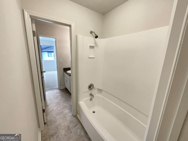 bathroom with bathing tub / shower combination, vanity, and tile patterned flooring