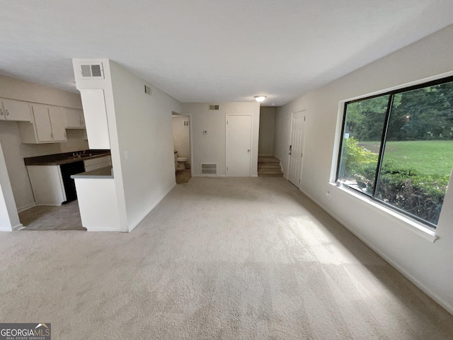 1472 Pine Log Rd NE, Conyers, GA 30012 - unfurnished living room featuring stairway and light colored carpet