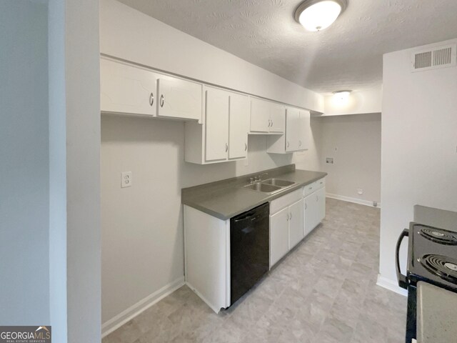 kitchen featuring range, black dishwasher, sink, light tile patterned floors, and white cabinetry