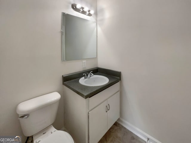 bathroom with vanity, tile patterned flooring, and toilet