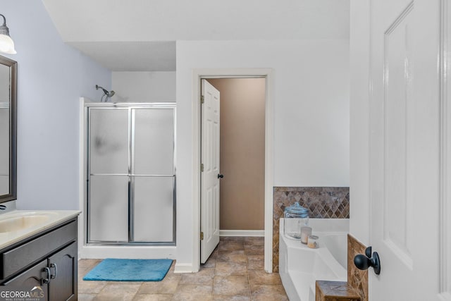 bathroom with vanity and shower with separate bathtub