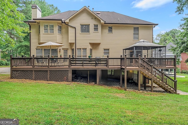 back of property with a gazebo, a yard, and a wooden deck