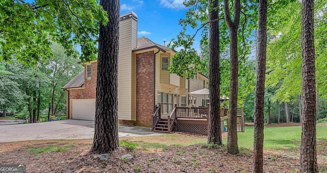 view of property exterior with a wooden deck and a garage