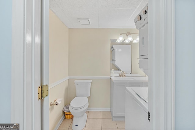 bathroom featuring a paneled ceiling, vanity, separate washer and dryer, tile patterned floors, and toilet