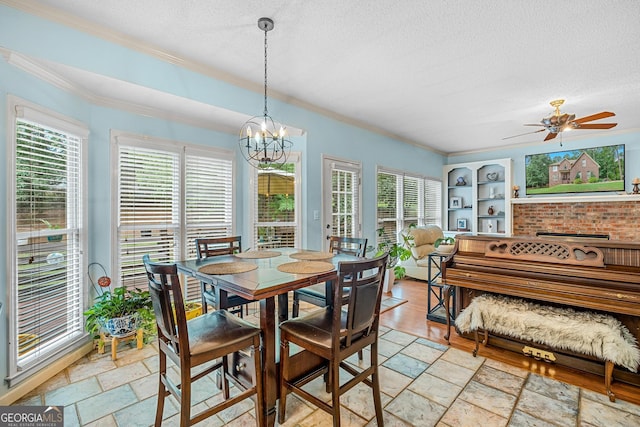 dining space featuring crown molding, ceiling fan with notable chandelier, a textured ceiling, and built in shelves