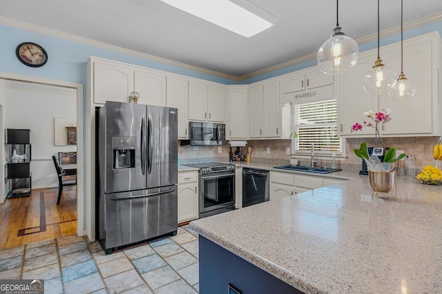 kitchen featuring appliances with stainless steel finishes, hanging light fixtures, ornamental molding, light stone countertops, and white cabinets