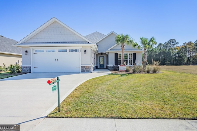 view of front of home with a front yard and a garage