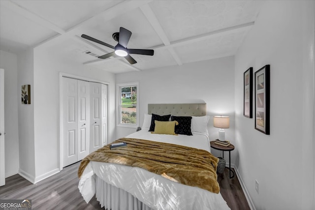 bedroom with a closet, ceiling fan, dark hardwood / wood-style flooring, and coffered ceiling