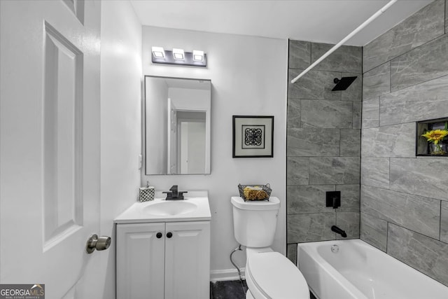 full bathroom featuring tiled shower / bath combo, vanity, and toilet