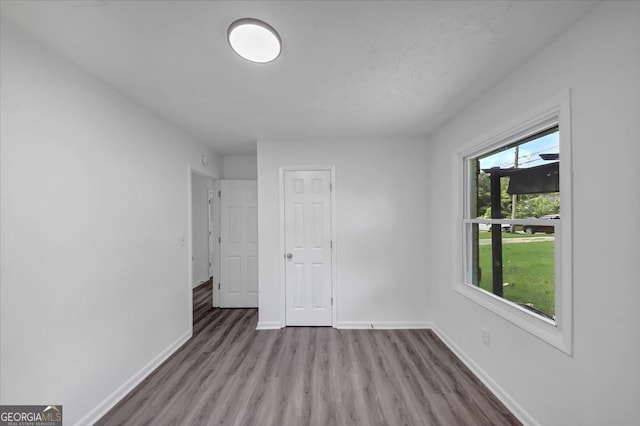 unfurnished bedroom featuring hardwood / wood-style flooring