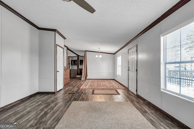 entryway featuring a healthy amount of sunlight, ornamental molding, and dark hardwood / wood-style floors