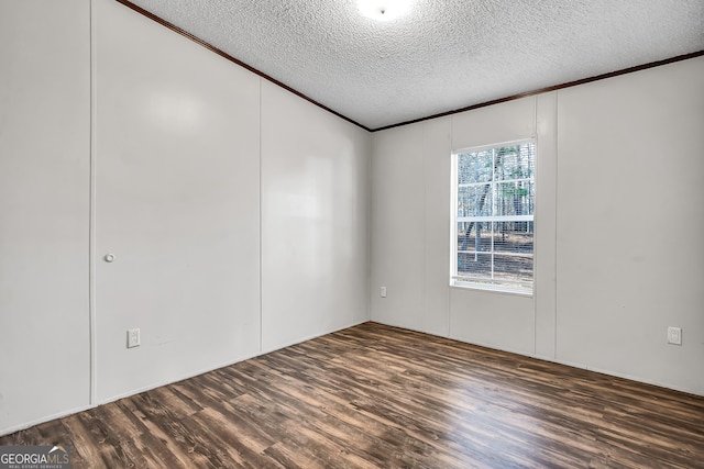 unfurnished room featuring a textured ceiling and dark hardwood / wood-style flooring