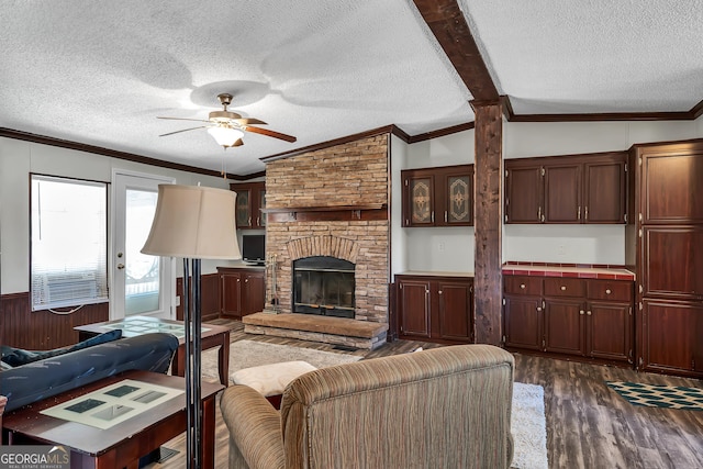 living room with lofted ceiling, a fireplace, wooden walls, dark hardwood / wood-style floors, and ornamental molding