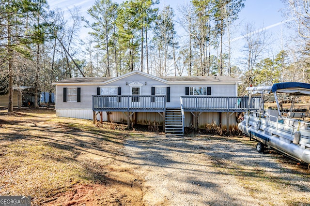 back of house featuring a wooden deck