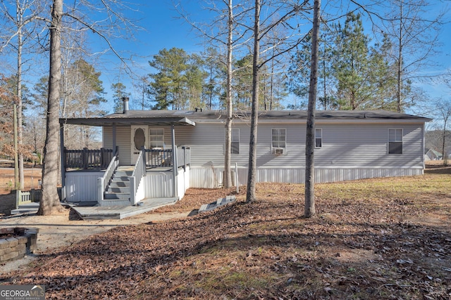 rear view of house featuring covered porch