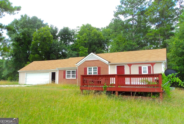 single story home featuring brick siding, a deck, and an attached garage