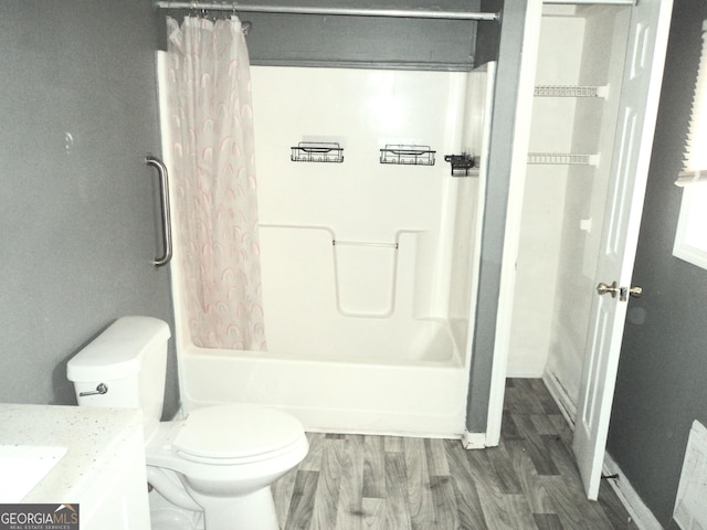 bathroom with toilet, shower / bathtub combination with curtain, wood finished floors, and vanity