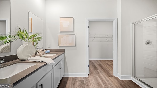 bathroom with vanity, hardwood / wood-style floors, and a shower with shower door