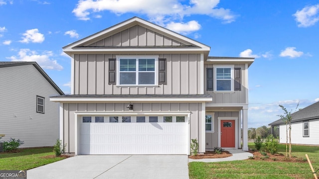 view of front of property featuring a garage and a front yard