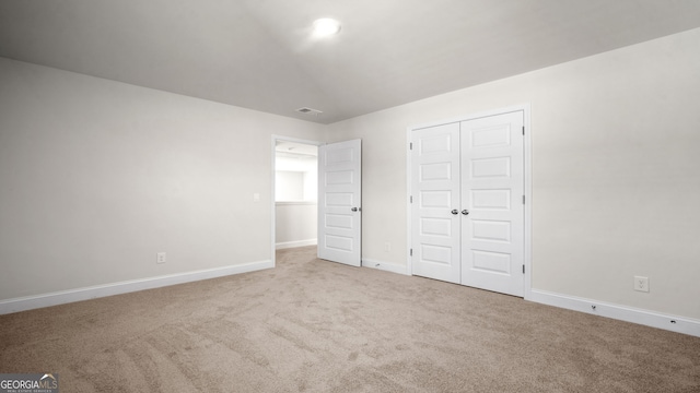 unfurnished bedroom with carpet and a closet