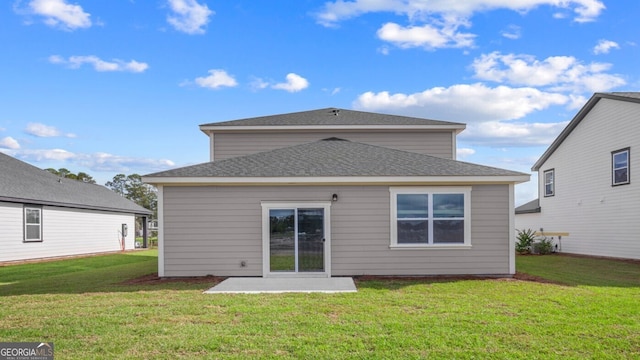 rear view of property featuring a patio area and a lawn