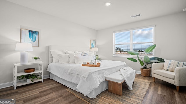 bedroom with dark hardwood / wood-style flooring