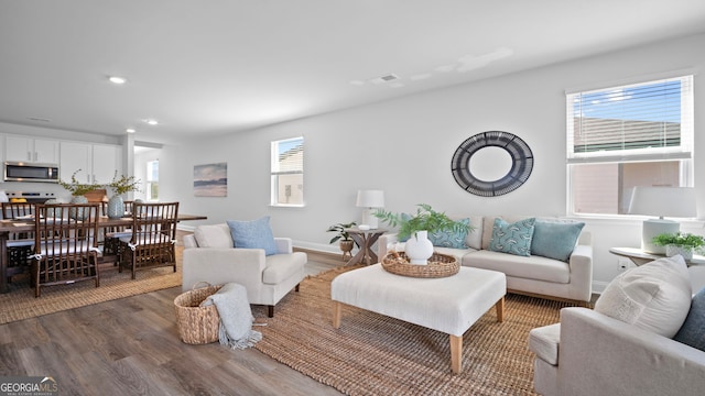 living room with visible vents, plenty of natural light, wood finished floors, and recessed lighting