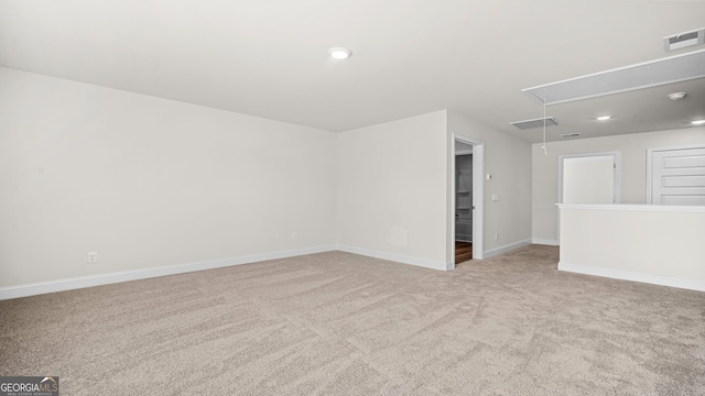 unfurnished room featuring light carpet