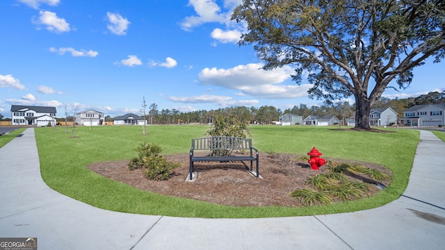 view of property's community with a residential view and a yard