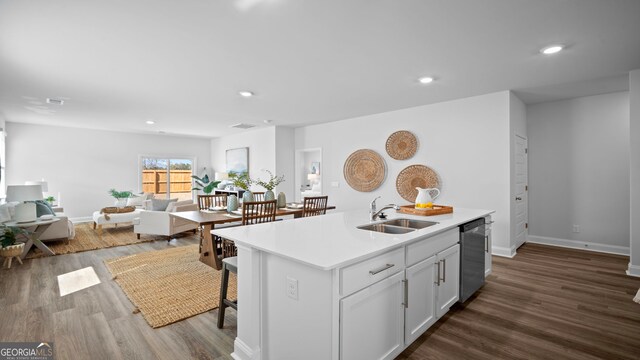 kitchen featuring an island with sink, stainless steel appliances, a breakfast bar, and sink