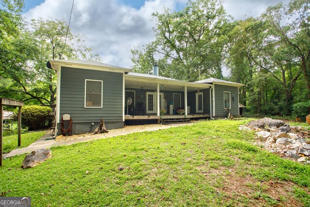 rear view of house with a yard