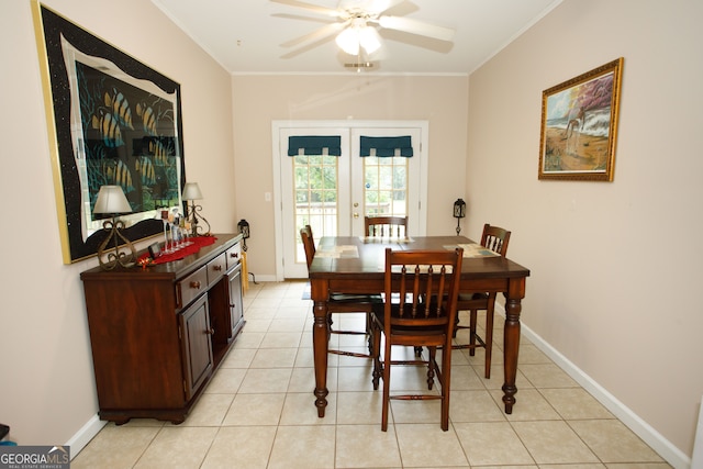 tiled dining area with ornamental molding, ceiling fan, and french doors