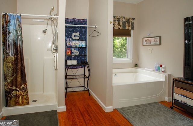 bathroom with separate shower and tub and hardwood / wood-style flooring