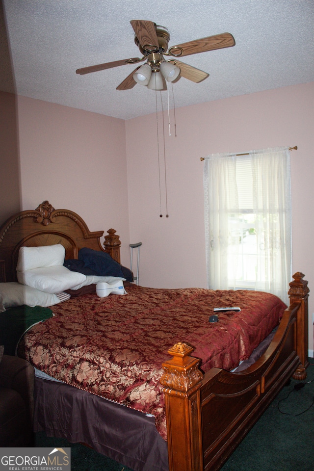 bedroom with a textured ceiling, ceiling fan, and carpet flooring