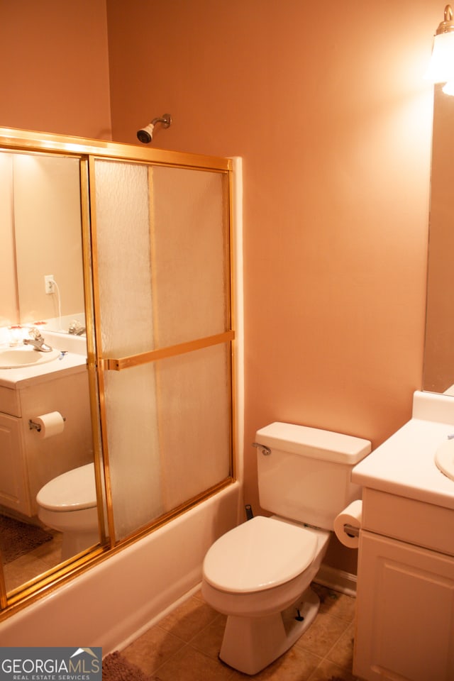 full bathroom with tile patterned flooring, toilet, vanity, and enclosed tub / shower combo