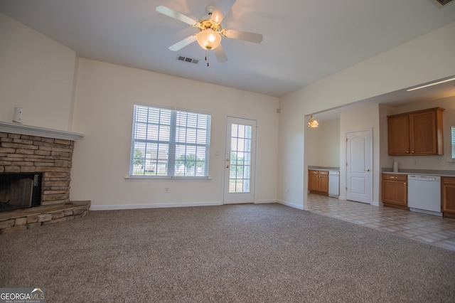 unfurnished living room featuring a fireplace, light tile patterned floors, and ceiling fan