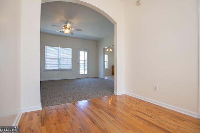 carpeted empty room featuring ceiling fan