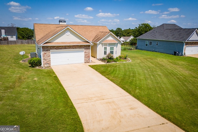 ranch-style house featuring a front yard, central AC unit, and a garage