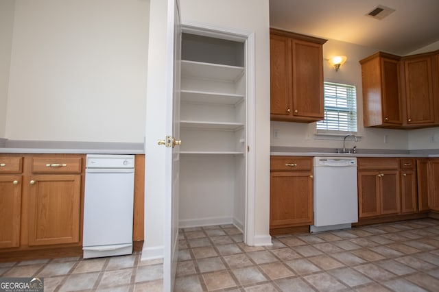 kitchen featuring light tile patterned flooring and dishwasher